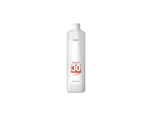A 1000ml bottle of professional Redken Pro-Oxide Cream Developer 30 Volume 9 percent for high-lift permanent coloring and hair bleaching